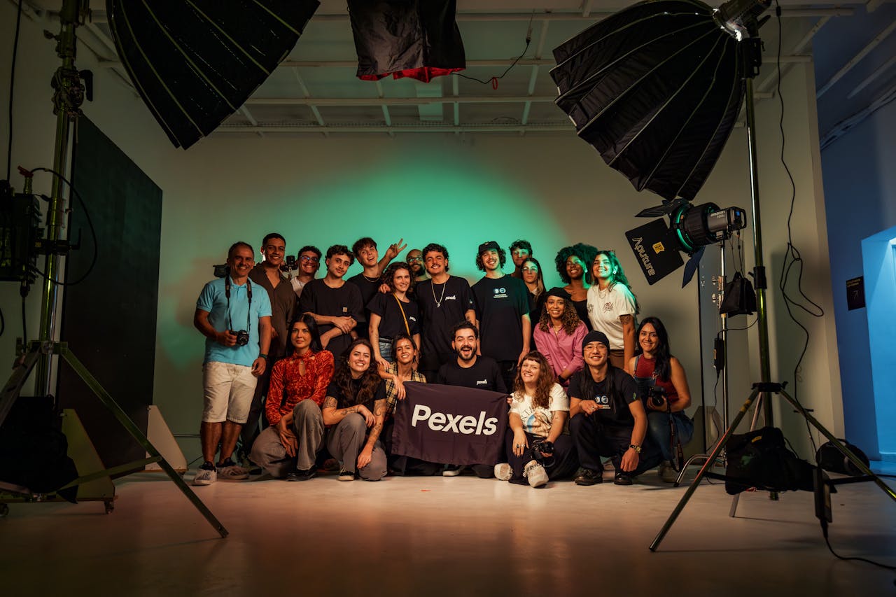 gallery-2 A diverse group of adults posing in a professional photography studio.