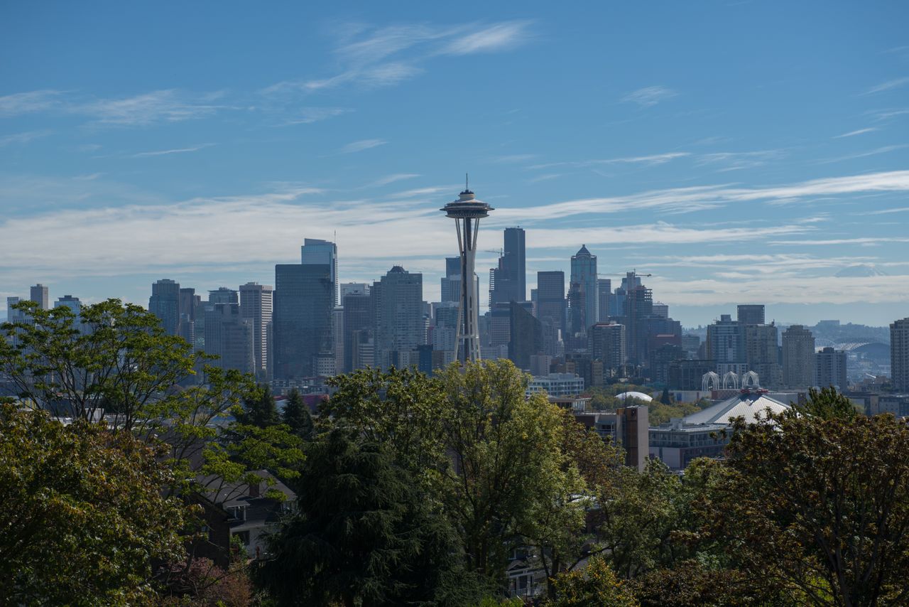 services-02 Panoramic view of Seattle with the iconic Space Needle under a clear blue sky.
