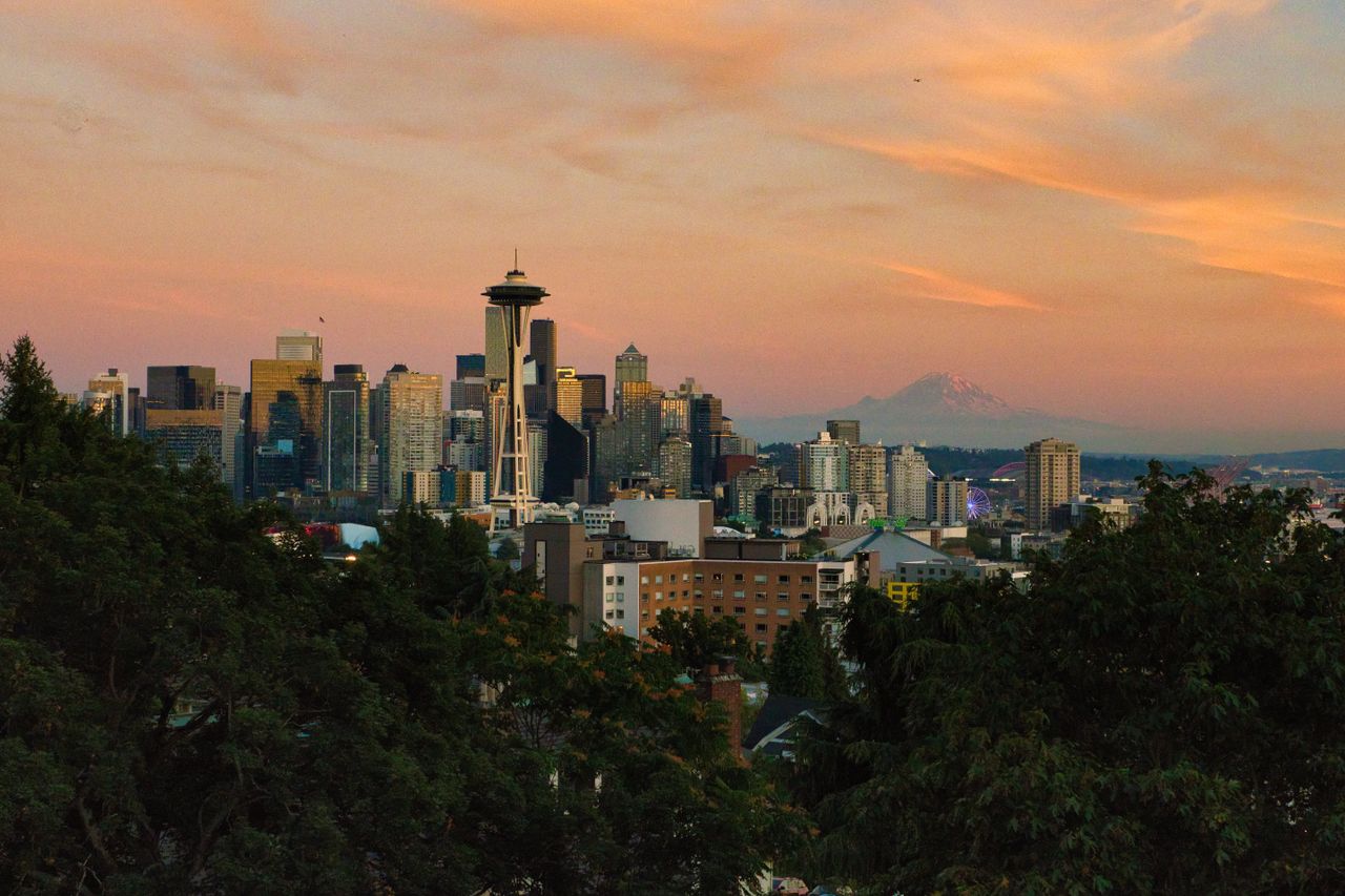 services-01 Stunning view of Seattle skyline at sunset featuring Space Needle and Mount Rainier.