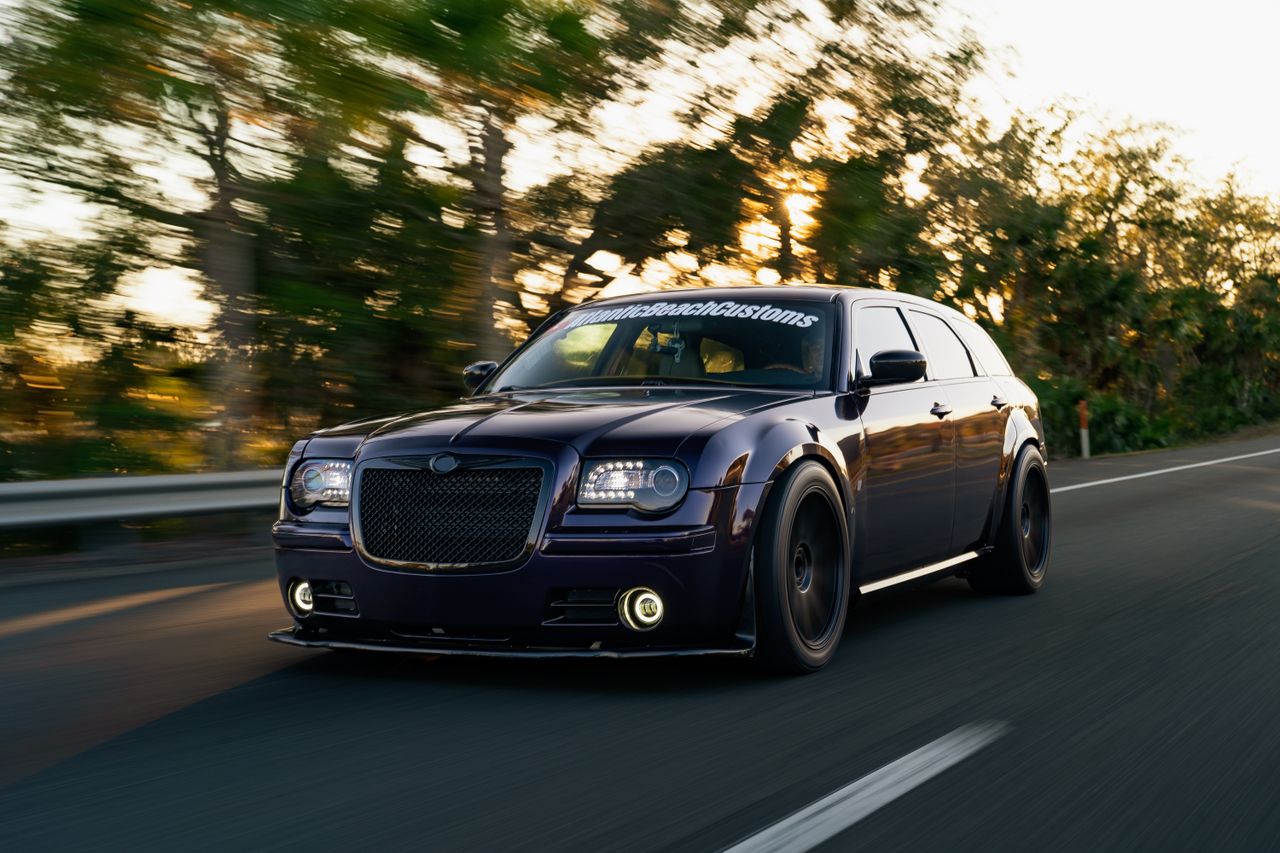 A custom luxury car speeding on a highway with vibrant motion blur, showcasing automotive design and performance.